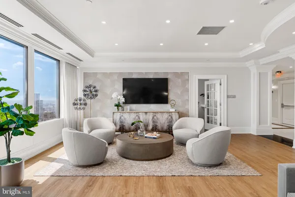 a living room with furniture or couch and a kitchen view