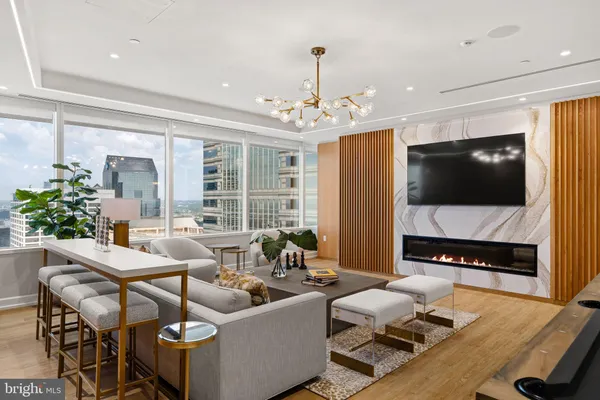 a kitchen with stainless steel appliances granite countertop a stove and a living room