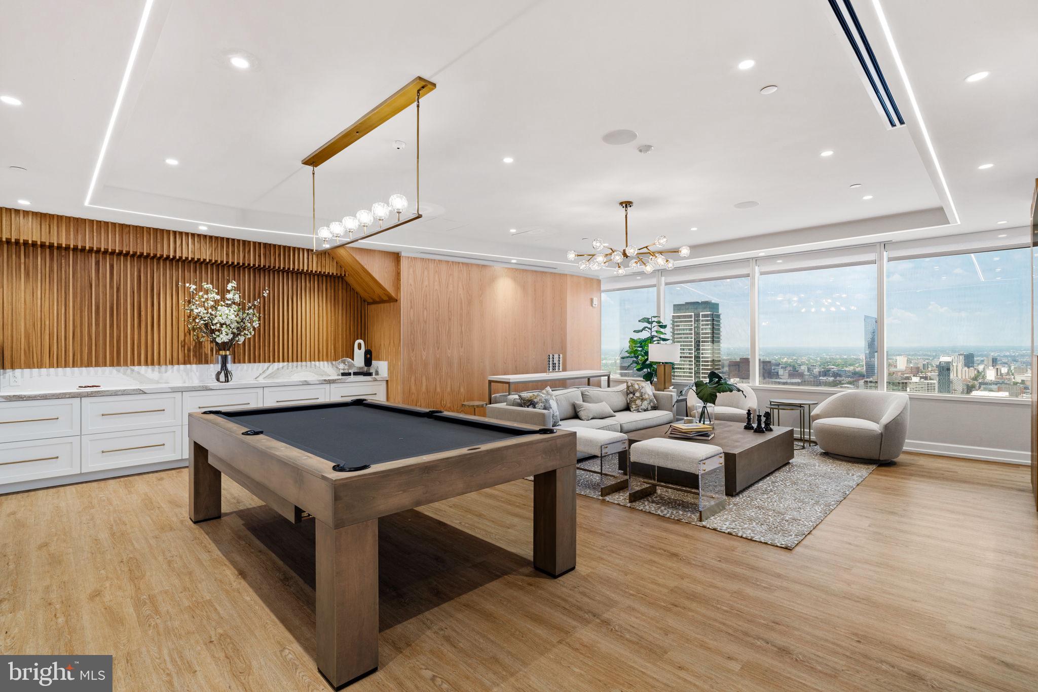 50 South 16th Street, Unit 4304 Philadelphia, PA 19103 - Photo 36 of 43 a kitchen with stainless steel appliances granite countertop a stove and a living room