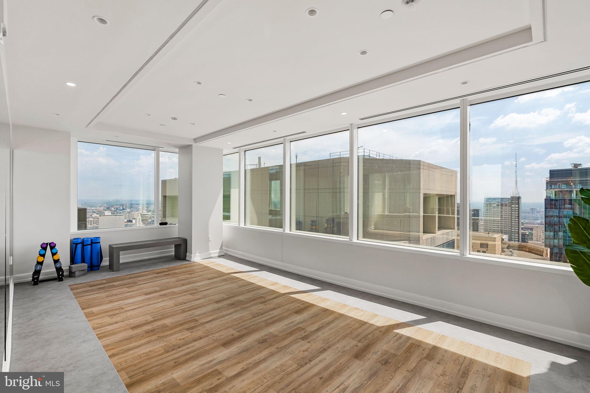 50 South 16th Street, Unit 4304 Philadelphia, PA 19103 - Photo 40 of 43 a living room with a large window and a wooden floor
