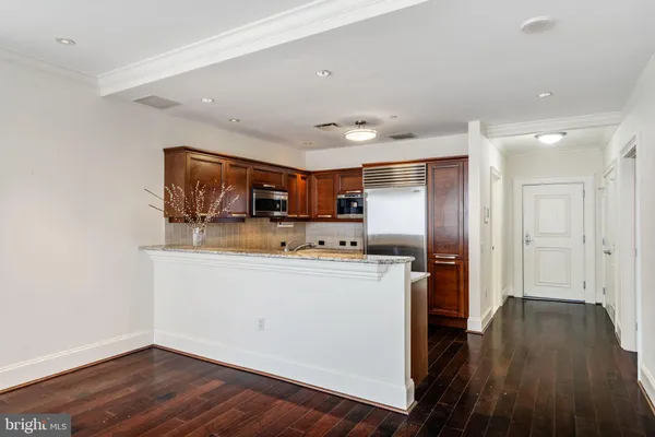 a kitchen with stainless steel appliances a refrigerator and a stove top oven