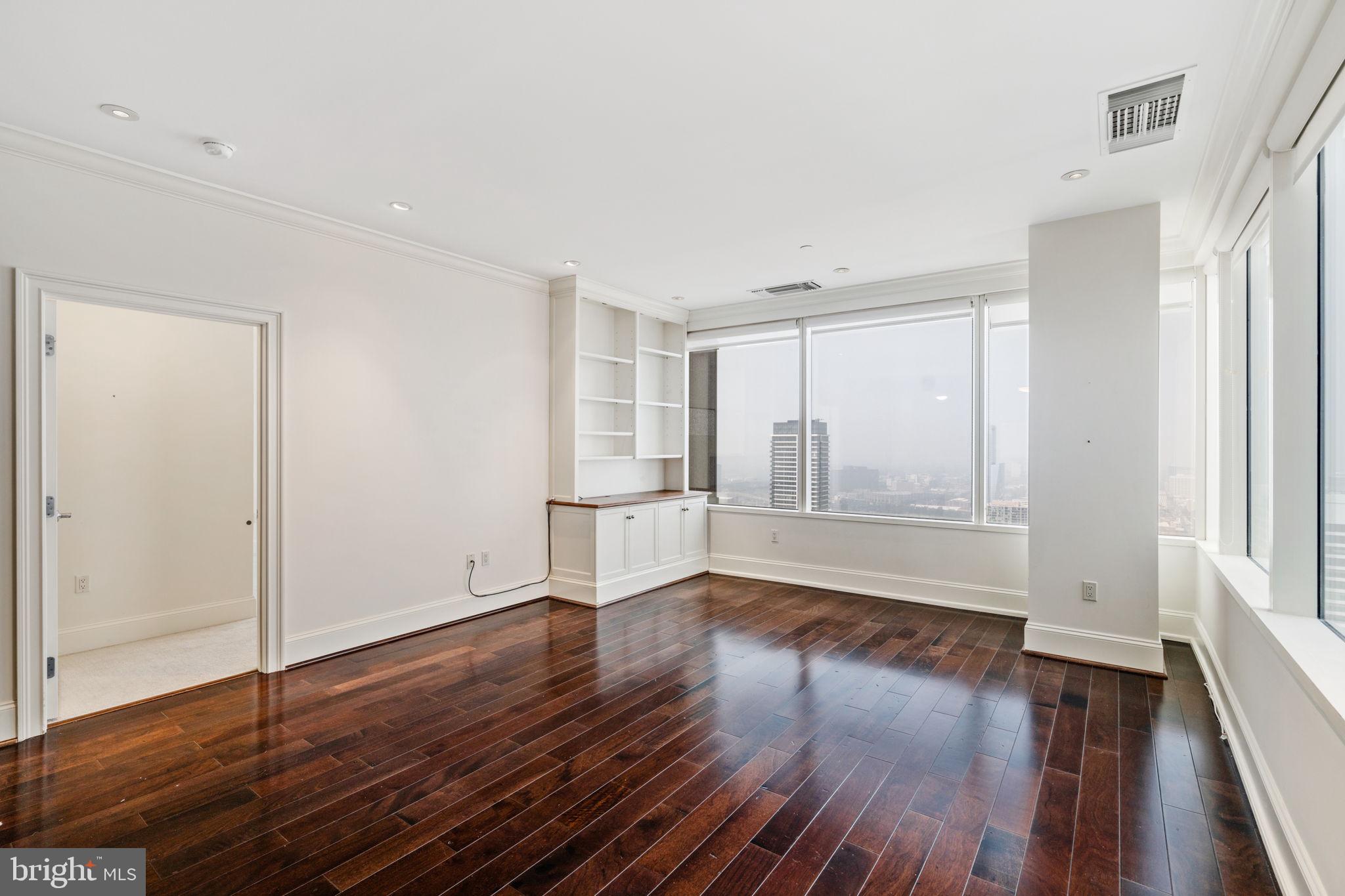 50 South 16th Street, Unit 4304 Philadelphia, PA 19103 - Photo 6 of 43 a view of an empty room with wooden floor and a window