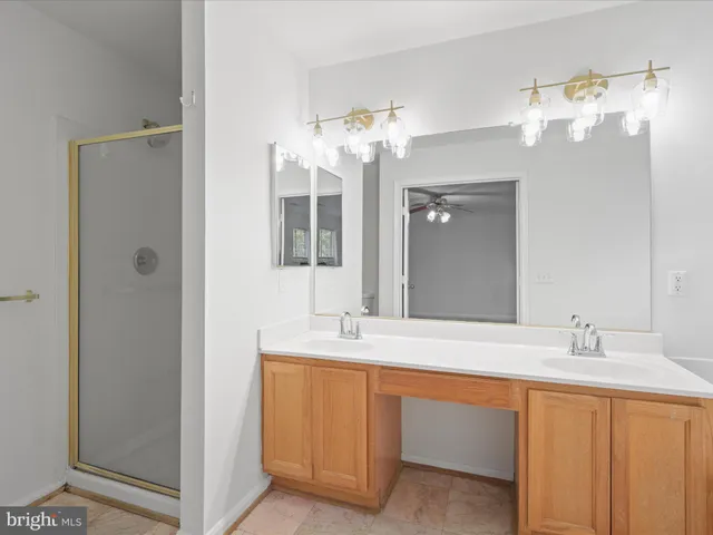 a bathroom with a double vanity sink and a mirror