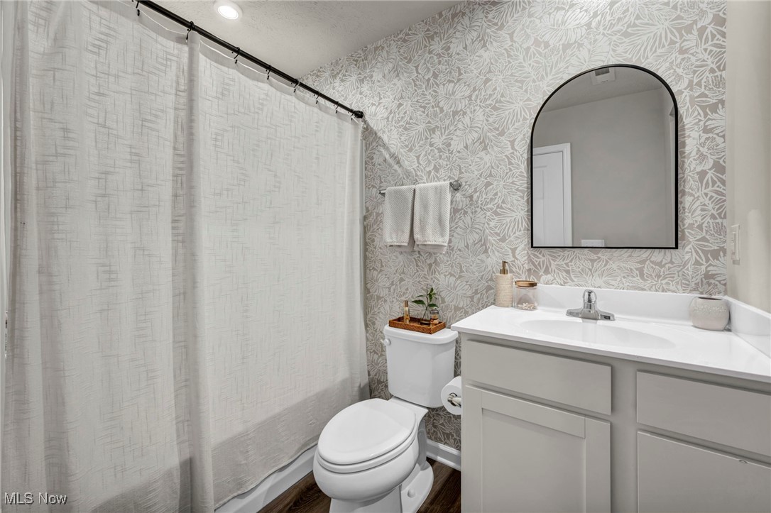 191 Raintree Lane Painesville, OH 44077 - Photo 25 of 35 Bathroom featuring vanity, shower / bath combo with shower curtain, and a textured ceiling