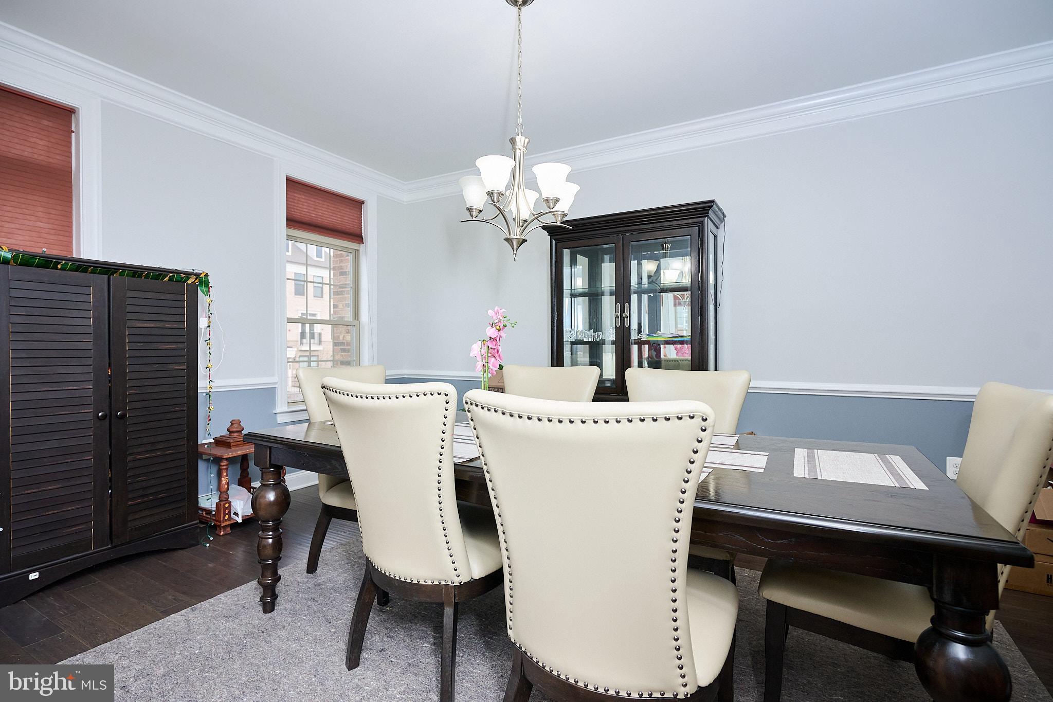22559 Windsor Locks Square Ashburn, VA 20148 - Photo 17 of 35 a view of a dining room with furniture window and wooden floor