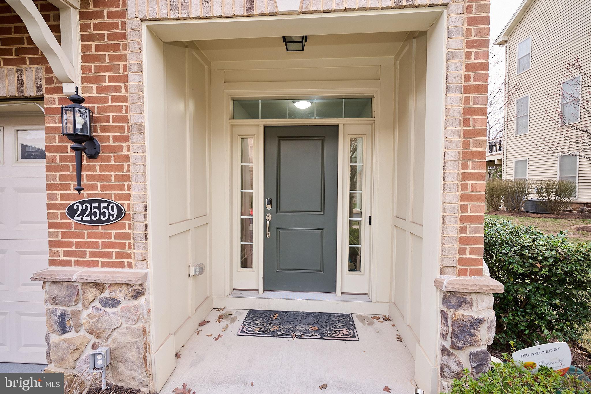 22559 Windsor Locks Square Ashburn, VA 20148 - Photo 2 of 35 view of a entryway door front of house