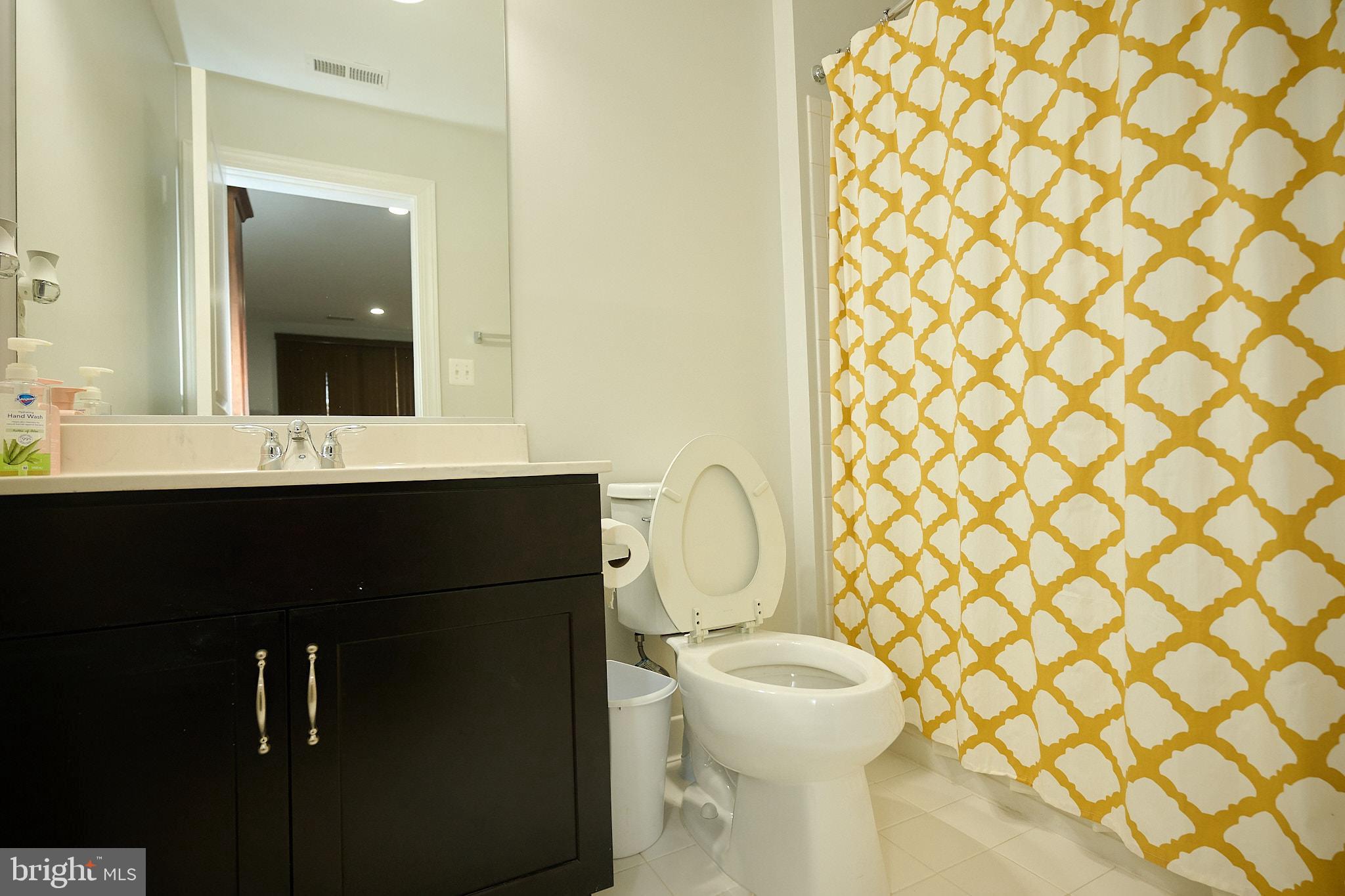 22559 Windsor Locks Square Ashburn, VA 20148 - Photo 21 of 35 a bathroom with a sink a toilet and mirror