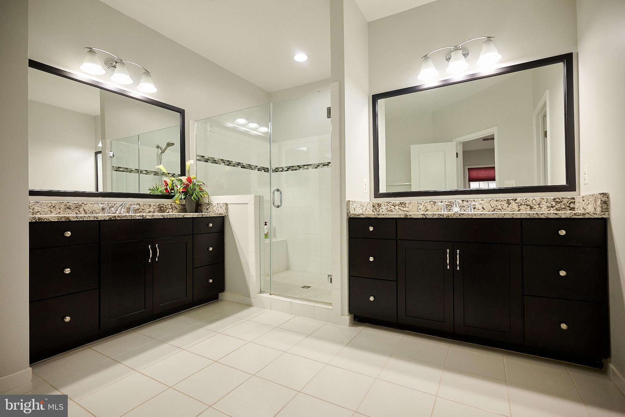 22559 Windsor Locks Square Ashburn, VA 20148 - Photo 28 of 35 a bathroom with a granite countertop double vanity sink and a mirror