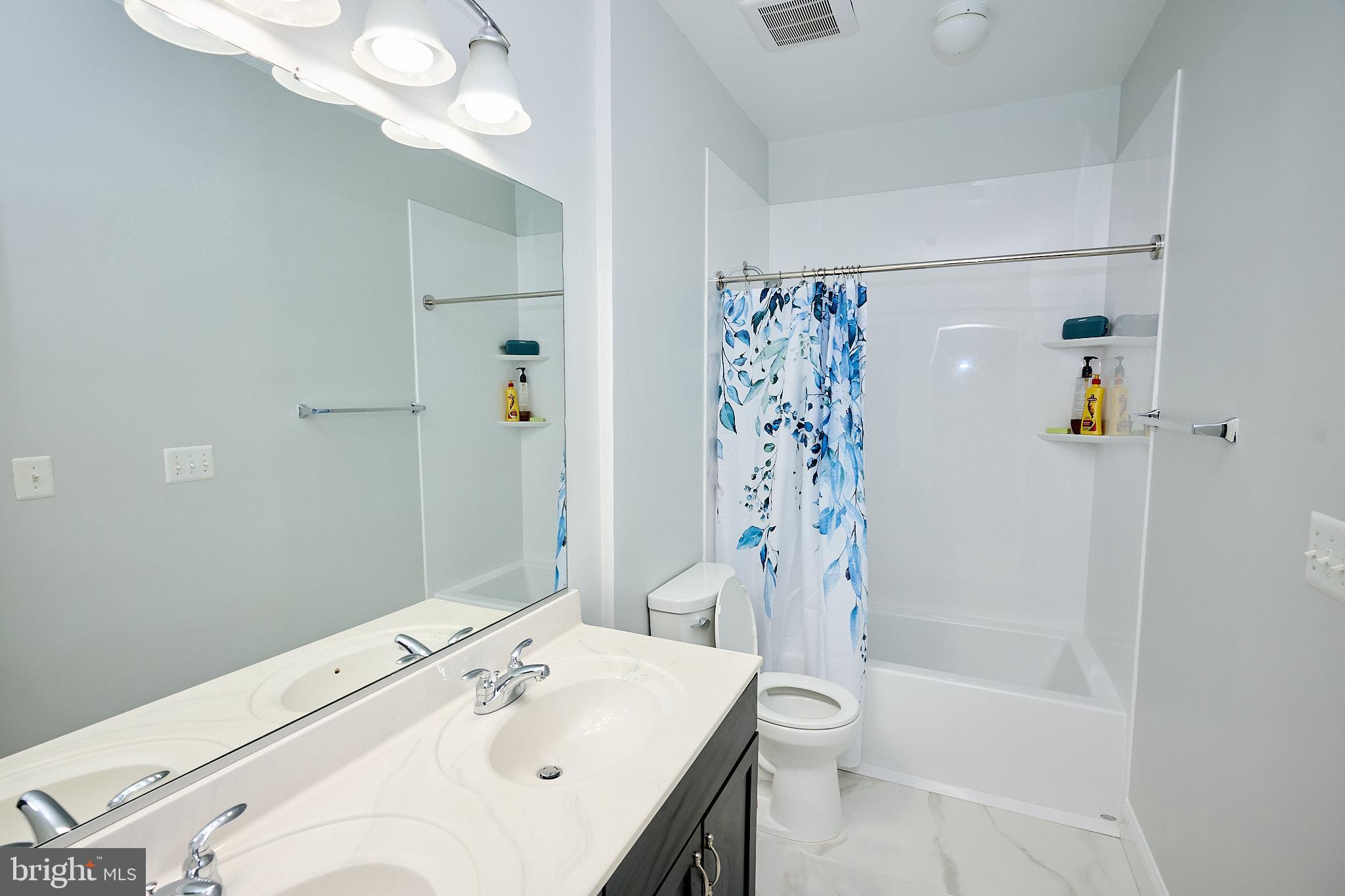 22559 Windsor Locks Square Ashburn, VA 20148 - Photo 32 of 35 a bathroom with a sink a toilet and shower