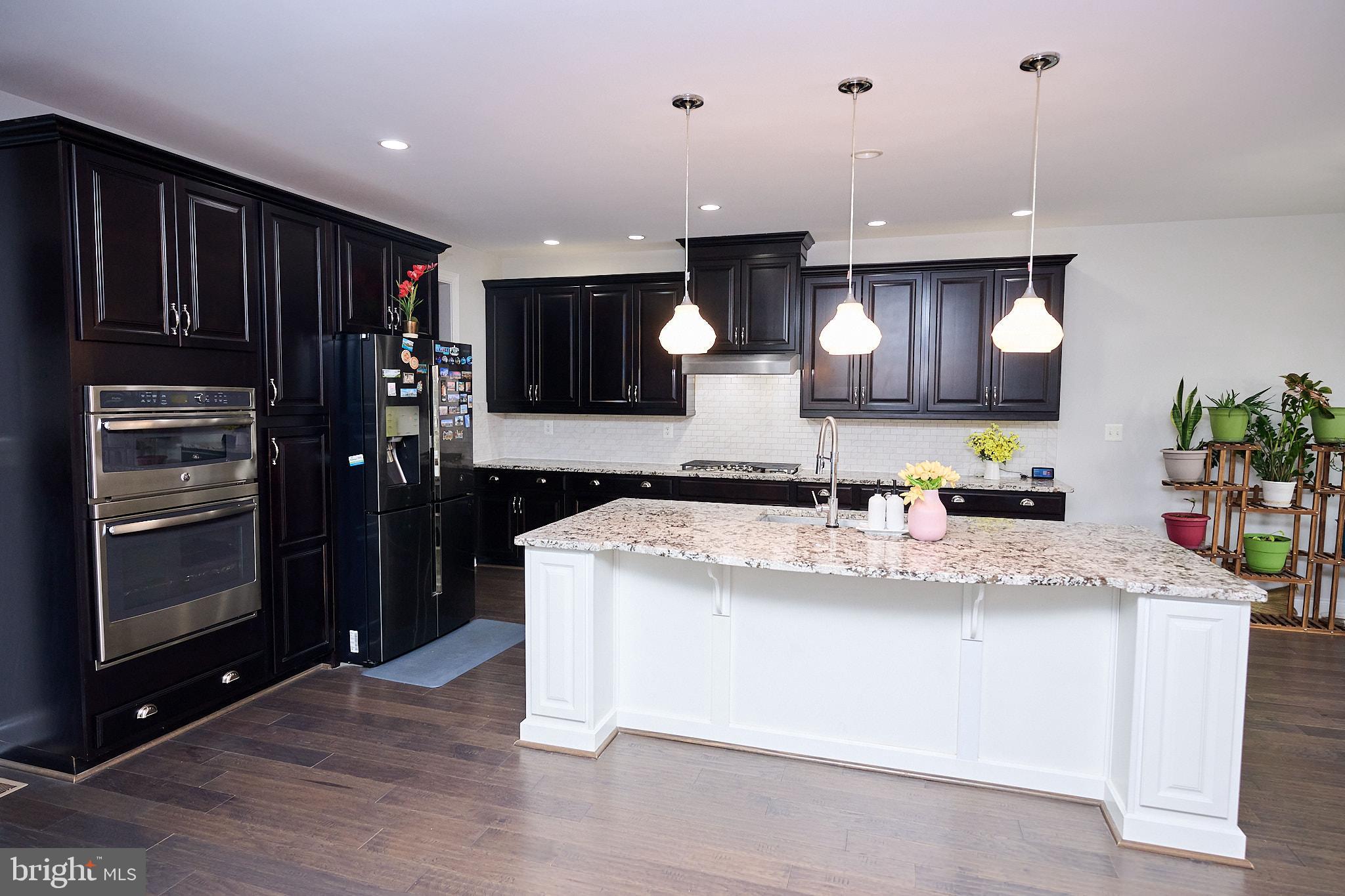 22559 Windsor Locks Square Ashburn, VA 20148 - Photo 6 of 35 a kitchen with stainless steel appliances granite countertop a sink a stove and a refrigerator
