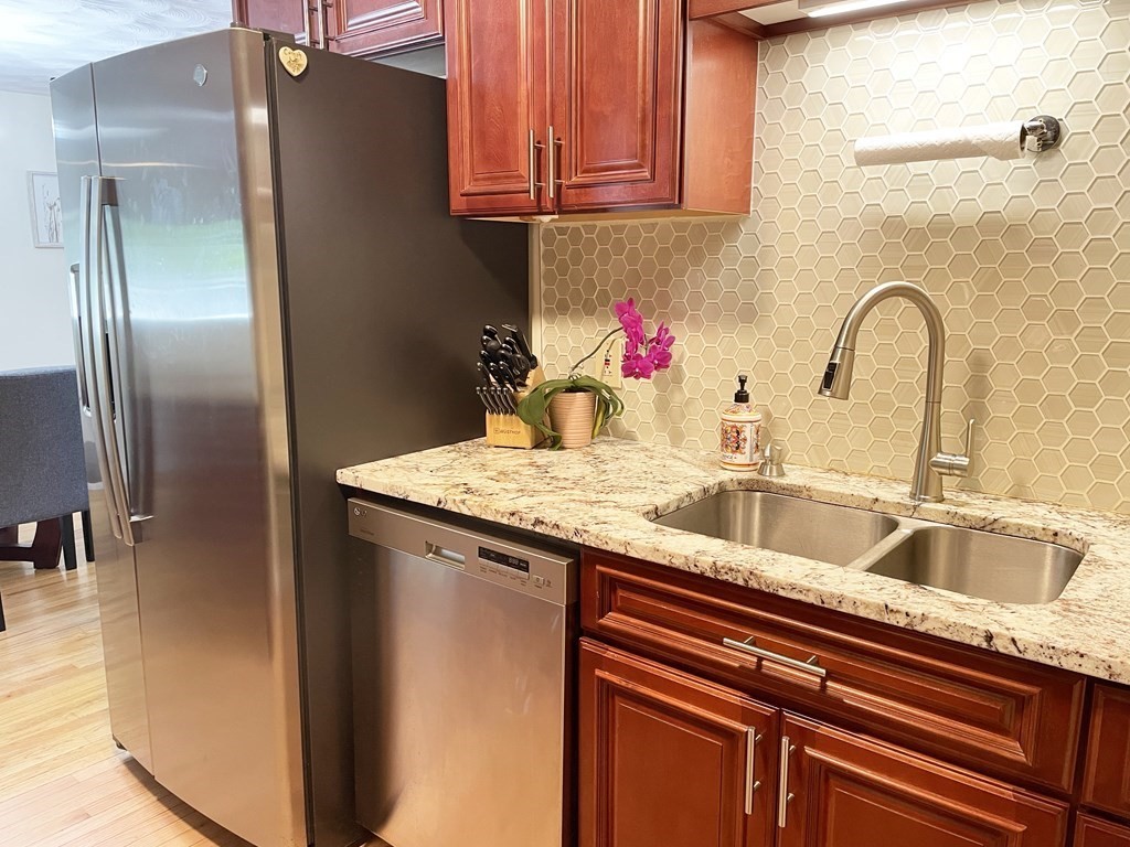 29 Karen Road Wakefield, MA 01880 - Photo 13 of 42 a kitchen with stainless steel appliances granite countertop a sink and cabinets