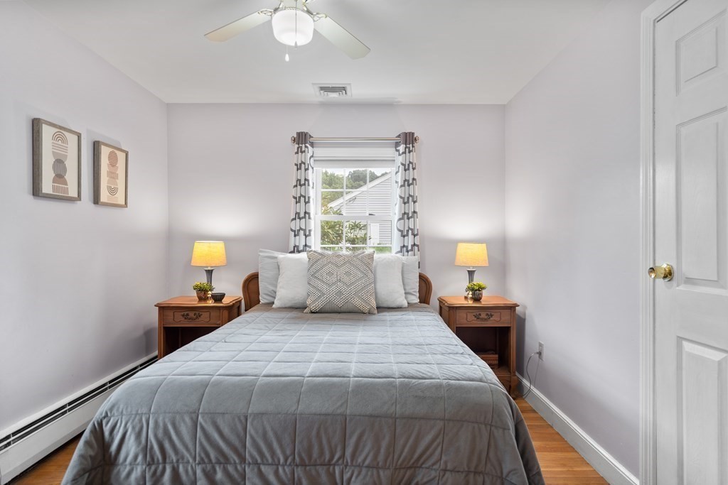 29 Karen Road Wakefield, MA 01880 - Photo 26 of 42 a bedroom with a bed and a chandelier