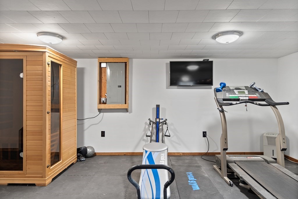 29 Karen Road Wakefield, MA 01880 - Photo 30 of 42 a room with gym equipment and a flat screen tv