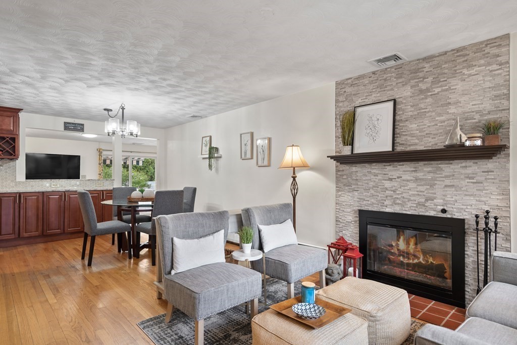 29 Karen Road Wakefield, MA 01880 - Photo 7 of 42 a living room with furniture a flat screen tv and a fireplace
