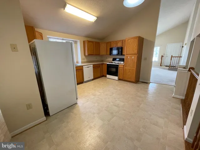 a kitchen with stainless steel appliances a refrigerator and a sink