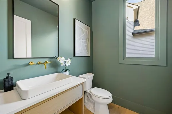 a bathroom with a toilet sink a mirror a bathtub and shower