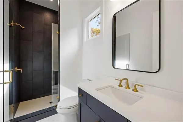 a bathroom with a sink toilet and shower