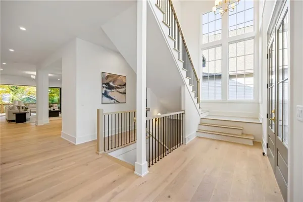 a living room with furniture a chandelier and a fireplace