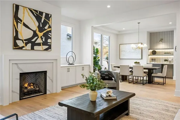 a kitchen with stainless steel appliances granite countertop a table chairs sink and stove top oven