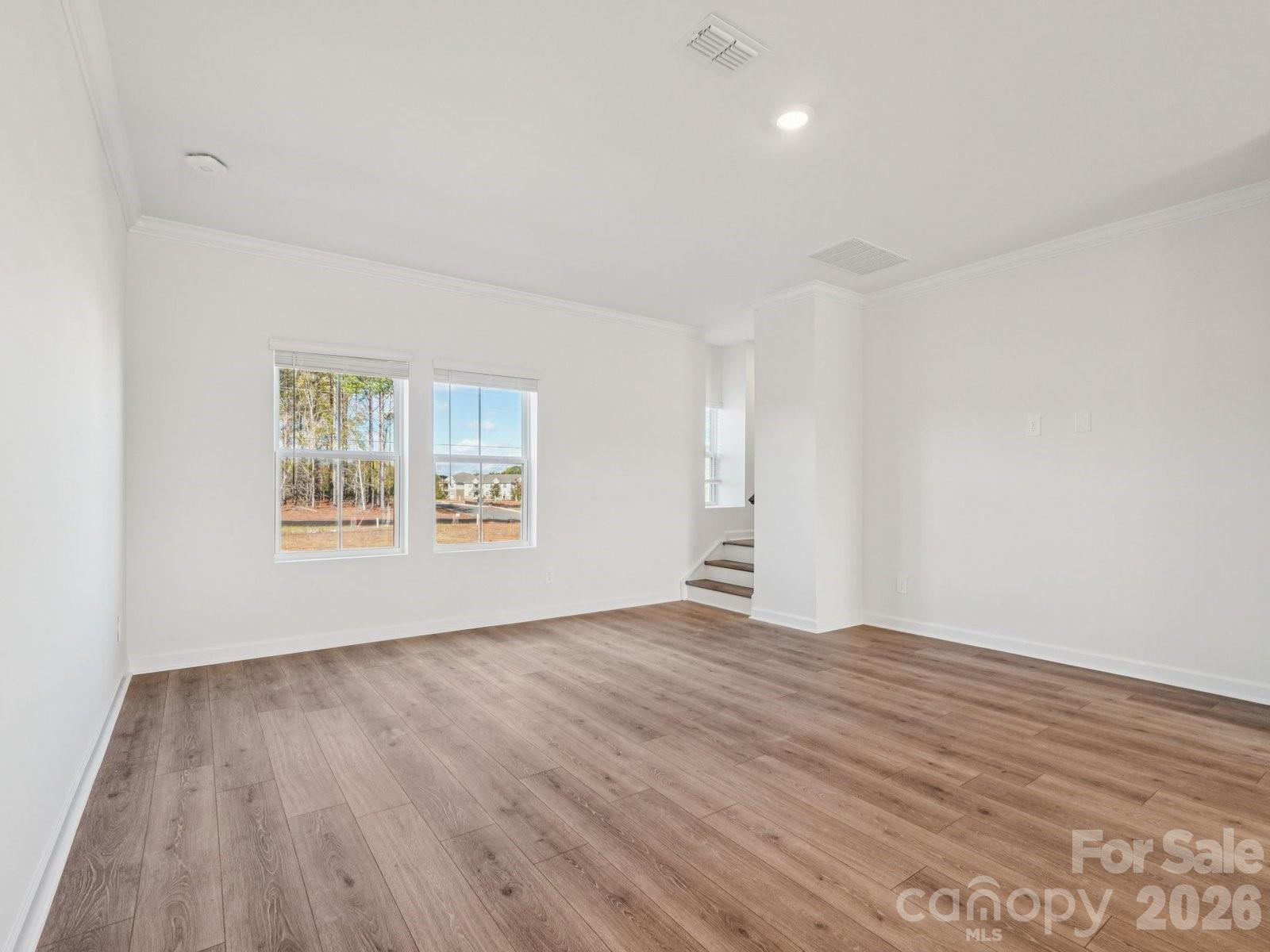 327 Golden Maple Court Fort Mill, SC 29708 - Photo 5 of 18 a view of an empty room with wooden floor and a window