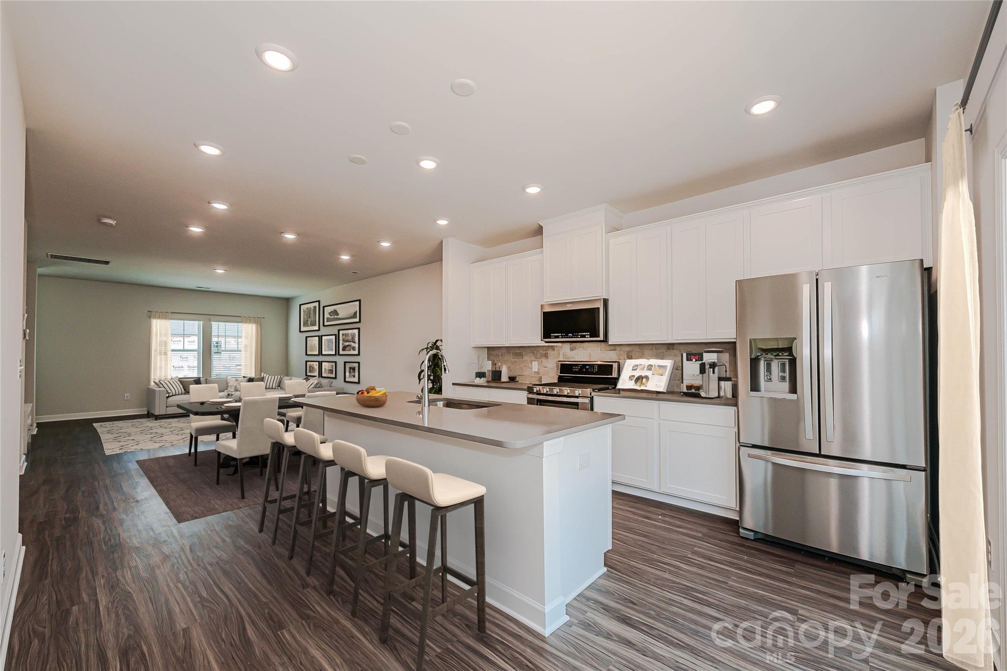 327 Golden Maple Court Fort Mill, SC 29708 - Photo 7 of 18 a large kitchen with stainless steel appliances lots of counter space and wooden floor