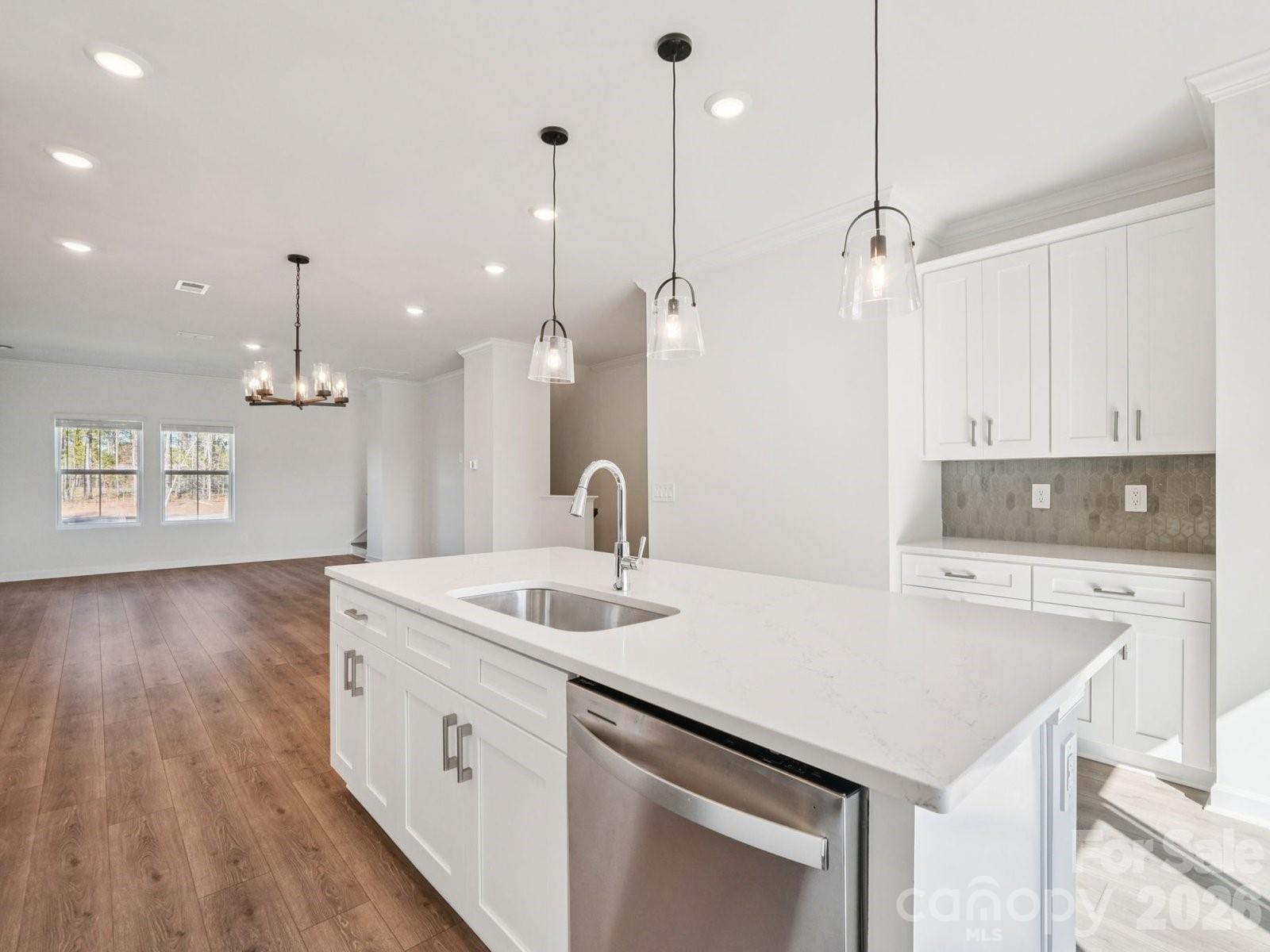 327 Golden Maple Court Fort Mill, SC 29708 - Photo 10 of 18 a kitchen that has a sink a stove and a wooden floor