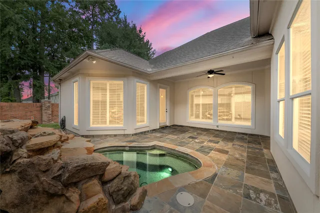 a living room with a bed furniture and a large window