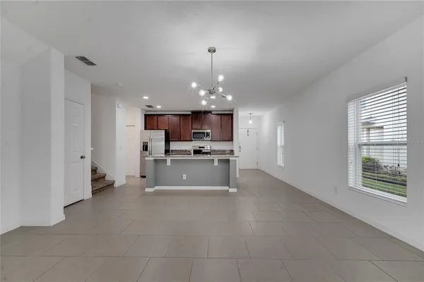 a kitchen with kitchen island granite countertop white cabinets and stainless steel appliances