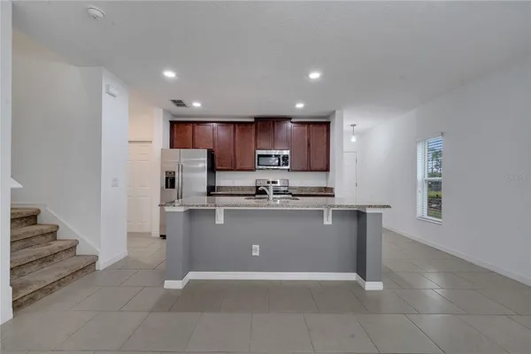 a kitchen with stainless steel appliances a refrigerator and a stove