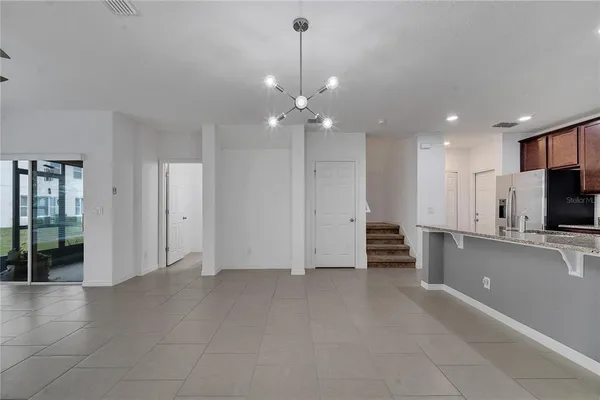 an empty room with fireplace and windows