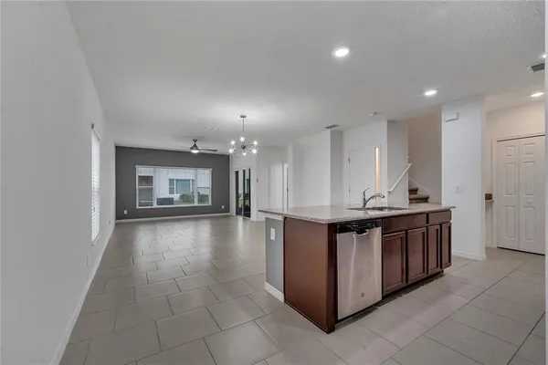 a kitchen with stainless steel appliances granite countertop a sink a stove and a refrigerator
