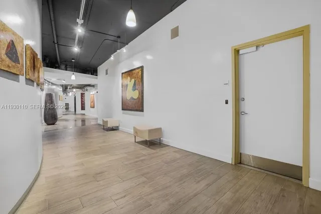 a view of a hallway with wooden floor