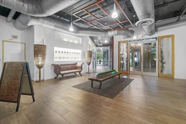 a living room with furniture a large window with wooden floor