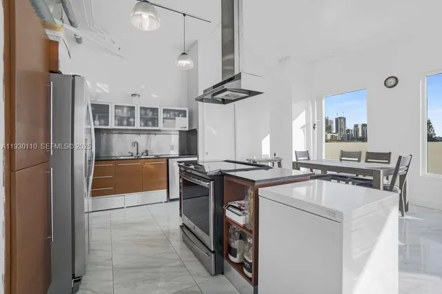 a kitchen with stainless steel appliances granite countertop a stove and a refrigerator