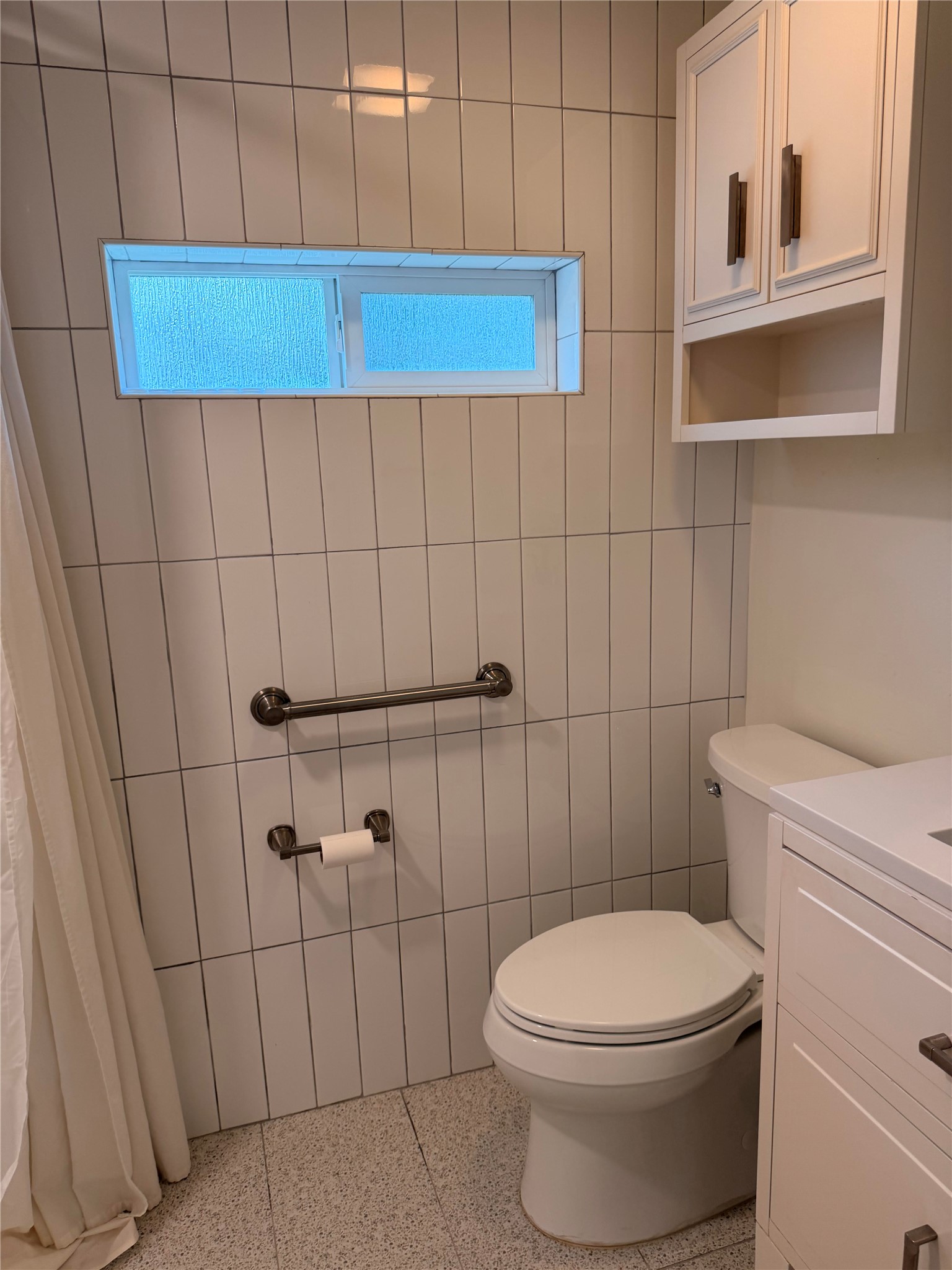 1182 Pandora Street Austin, TX 78702 - Photo 12 of 19 White subway tiles and a practical window adorn this well-appointed bathroom.