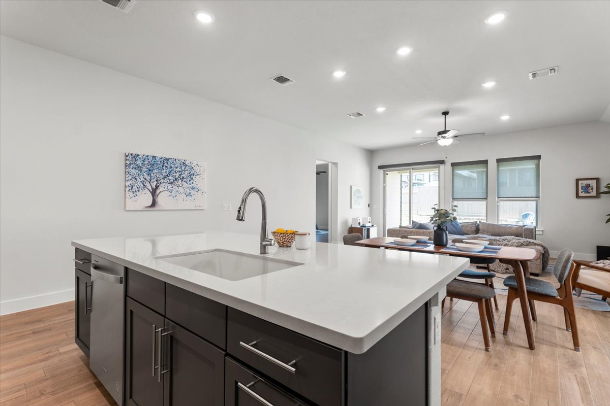 8501 Hillock Terrace Austin, TX 78744 - Photo 11 of 32 a kitchen with a table chairs and wooden floor