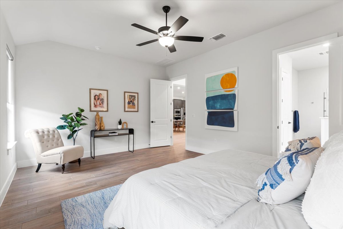 8501 Hillock Terrace Austin, TX 78744 - Photo 19 of 32 a bedroom with a bed and a chair