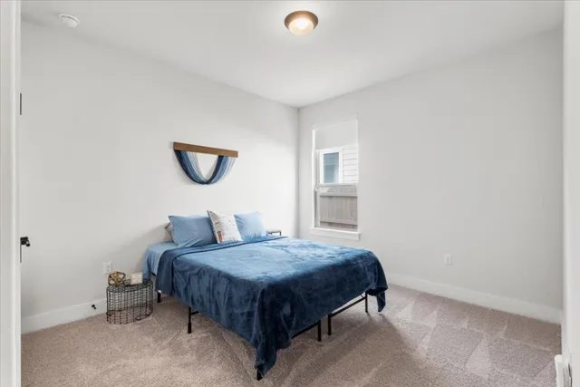 a bedroom with a bed and a table