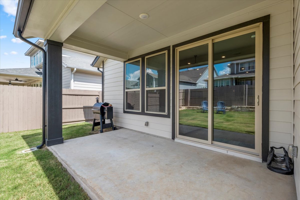 8501 Hillock Terrace Austin, TX 78744 - Photo 28 of 32 a view of a room with a large window and wooden floor