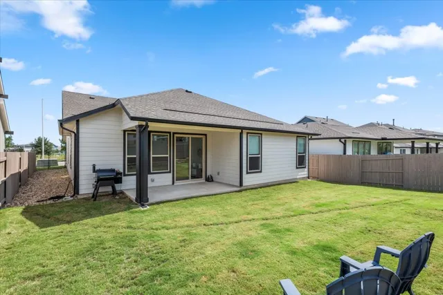a view of a house with a yard and sitting area