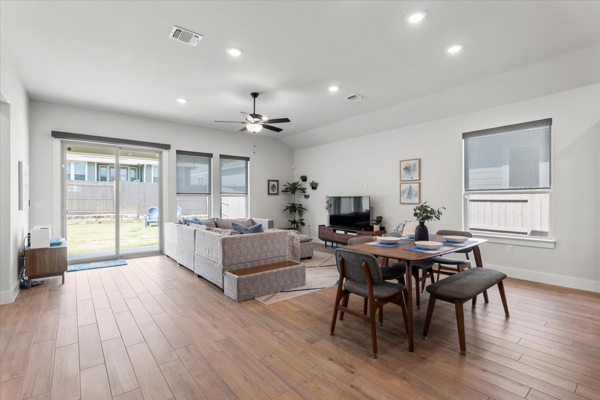 8501 Hillock Terrace Austin, TX 78744 - Photo 3 of 32 a view of a dining room with furniture window and wooden floor