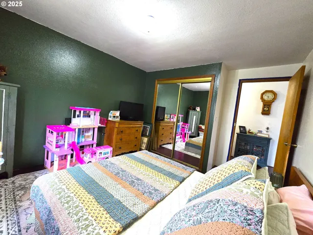 a bed room with a bed and a mirror