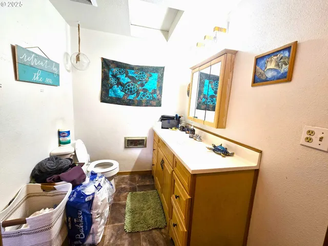 a bathroom with a sink mirror and toilet