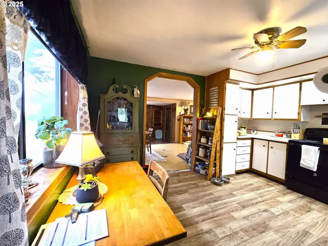a living room with stainless steel appliances kitchen island granite countertop furniture and a large window