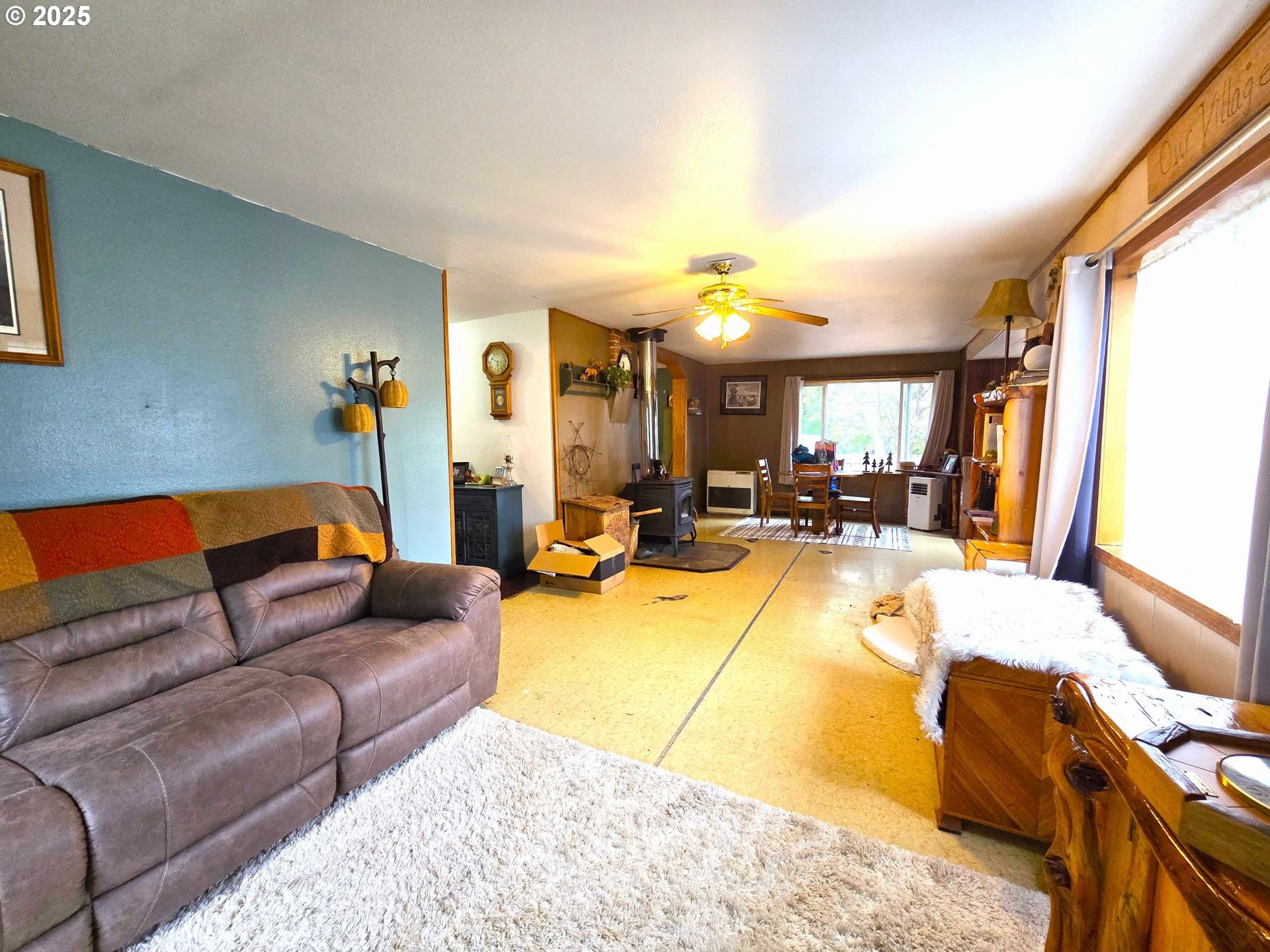 250 2nd Street Long Creek, OR 97856 - Photo 23 of 25 a living room with furniture and a chandelier