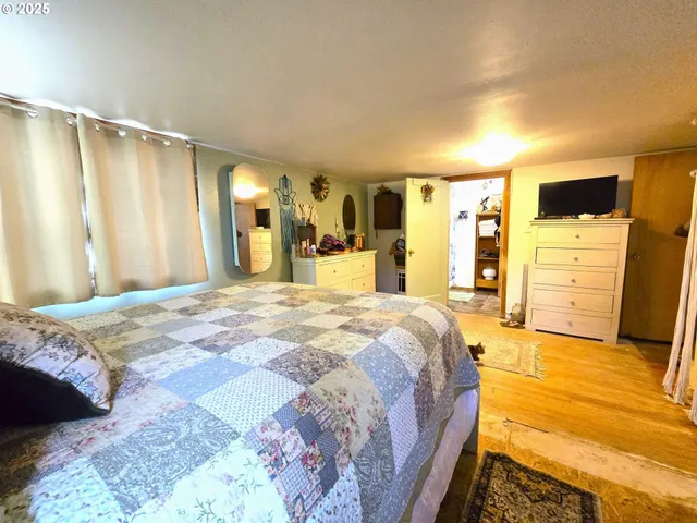 a spacious bedroom with a bed and walk in closet