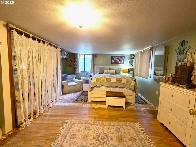a bedroom with furniture and a large window