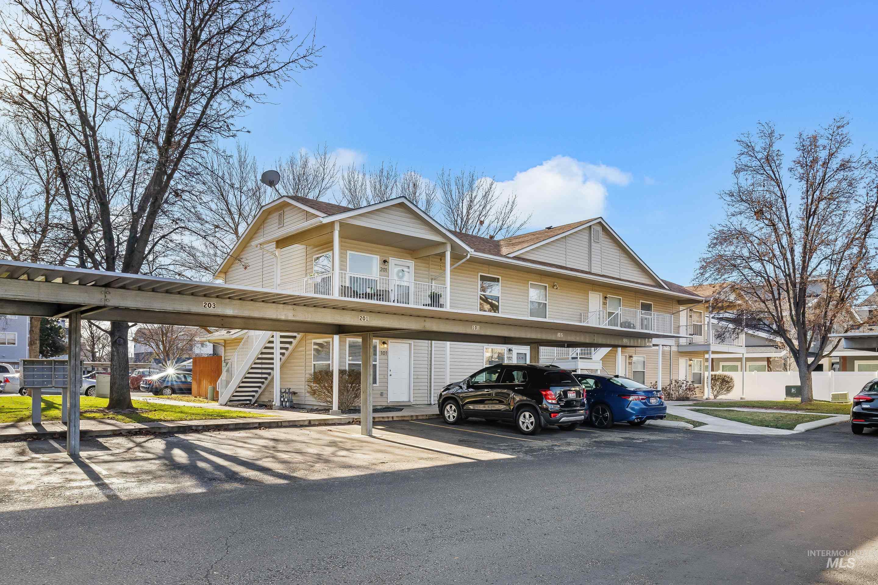 8909 West Irving Street, Unit 101 Boise, ID 83704 - Photo 2 of 33 View of front of property featuring covered parking