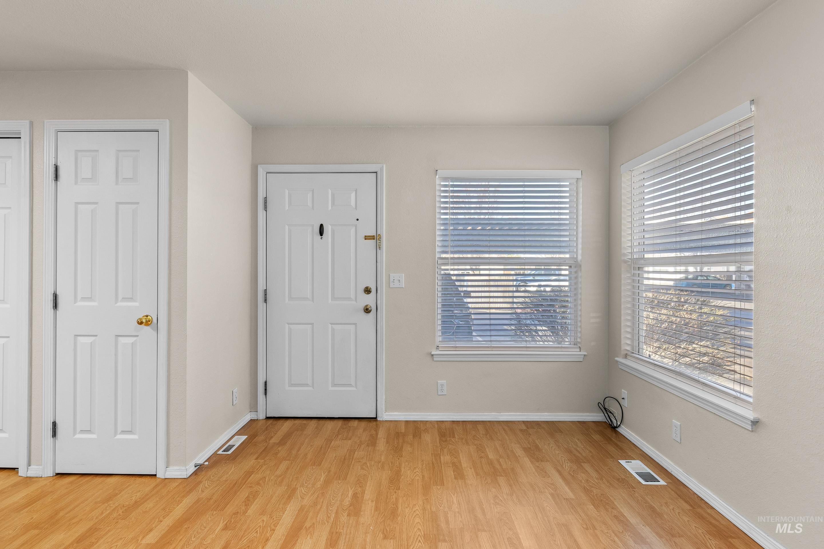 8909 West Irving Street, Unit 101 Boise, ID 83704 - Photo 5 of 33 Entryway featuring light wood-style floors and baseboards