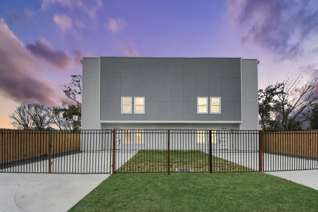 a view of a house with a yard and deck